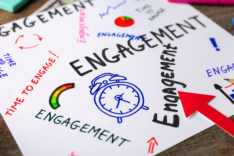 Sheet of paper with written words ENGAGEMENT on table, closeup