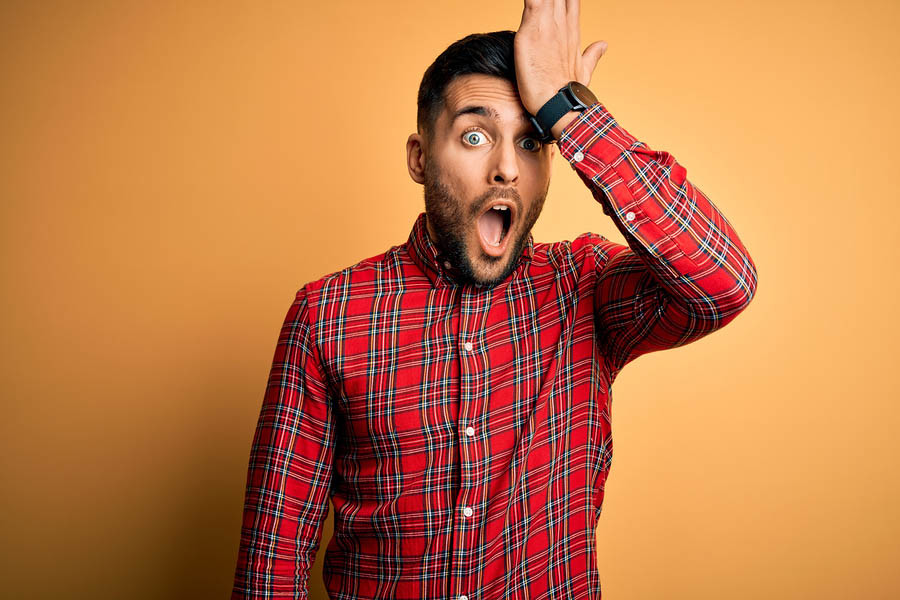 Young handsome man wearing casual shirt standing over isolated