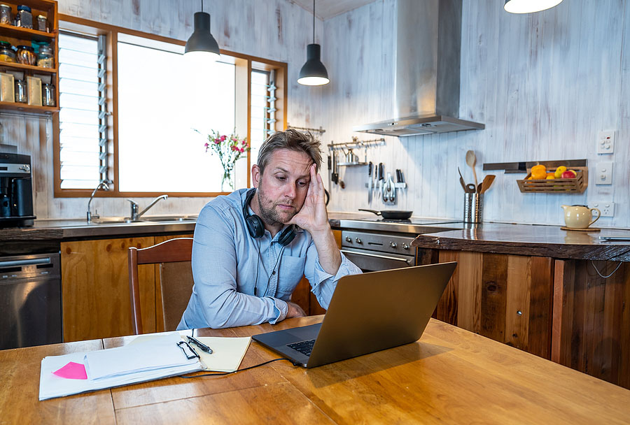 Stressed Business Man On Laptop Working From Home Looking Worrie